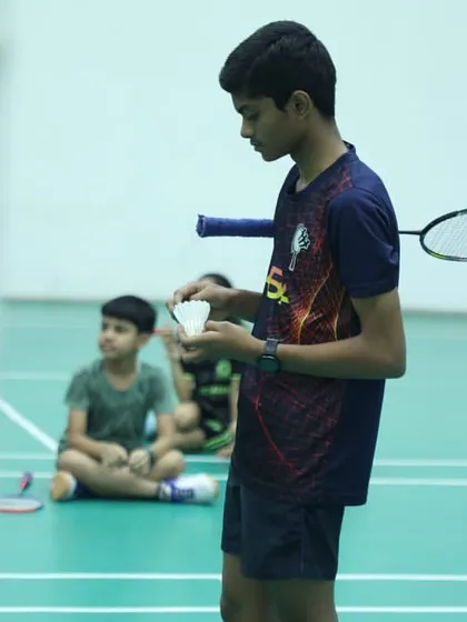A moment of intense focus before a serve. We teach our players that preparation and routine are just as important as the shot itself.