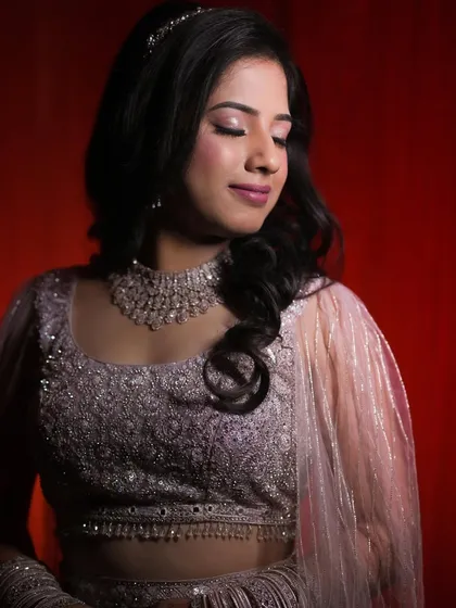 A beautiful shot of Shruti from her reception. Her look features a soft glitter eyeshadow and a subtle pink lip, creating a romantic and modern bridal style.