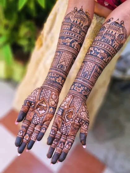 Another look at the full-arm traditional mehendi, highlighting the detailed elephants and floral bands that cover the arms from wrist to elbow.
