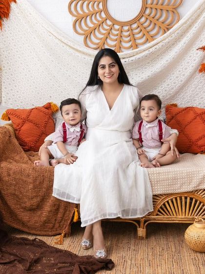 A mother's love, doubled. This portrait of a mom with her twin boys is overflowing with joy and affection.