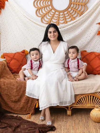 A mother with her twin boys in our rustic, boho-themed studio. Capturing the energy and love of a family with multiples is one of our specialties.