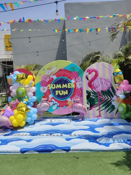 A "Summer Fun" themed photo booth, complete with a flamingo and tropical elements, ready for a pool party.
