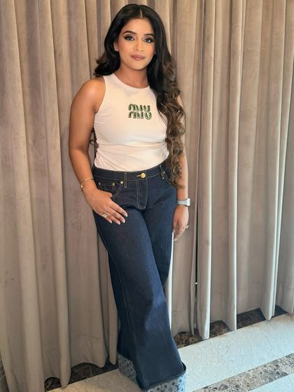 A full-length view of this matte magic look. The sharp eye makeup provides a fun contrast to the casual-chic outfit, showing how versatile a glam look can be.