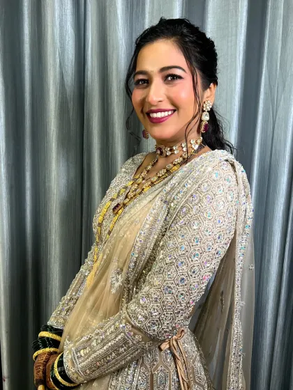 A happy portrait showcasing the complete reception look, including the traditional mangalsutra.