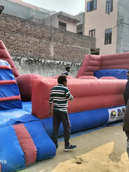 Our 'Baller Game' inflatable being inspected by potential clients. This 18x30 feet structure is a challenging and exciting attraction for any adventure park or large event.