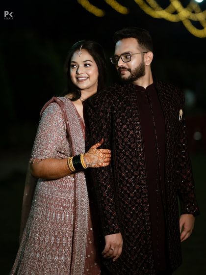 This photo shows the beautiful coordination between the couple's outfits and their makeup. Her soft look complements his sharp, classic attire perfectly.