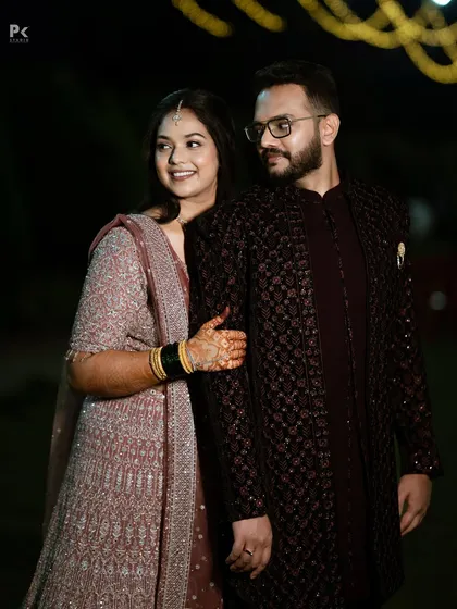 This photo shows the beautiful coordination between the couple's outfits and their makeup. Her soft look complements his sharp, classic attire perfectly.