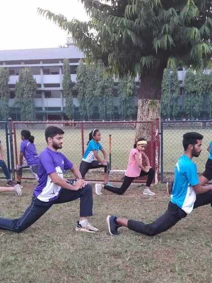 A group of athletes performing lunging stretches. We integrate proper stretching into every session to improve flexibility and aid recovery.