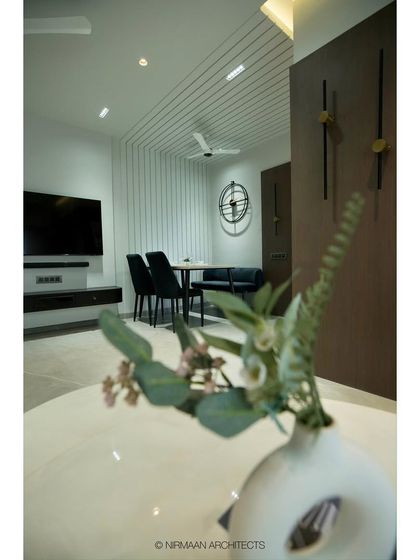 A different angle of the Tulsi Heights dining nook, showing its relationship to the TV unit and the rest of the living space. The design ensures a cohesive look throughout the open-plan area.