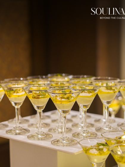 Elegant martini glasses filled with a light and refreshing dessert, ready to be served at a sophisticated wedding reception. Our presentation is always crafted to impress.