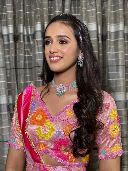 This glitter hairstyle is perfect for a Mehendi party. The glitter roots add a touch of unicorn magic to the half-updo with soft waves.