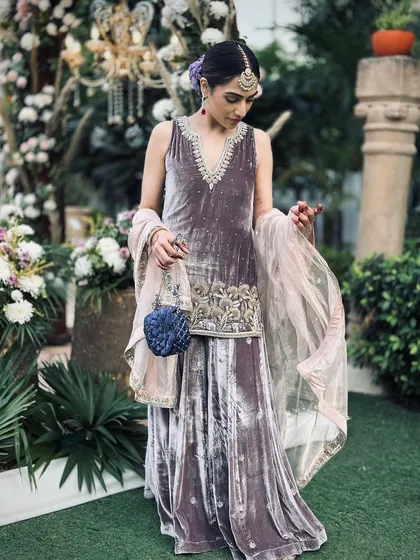 The full view of my self-designed velvet sharara. The color is unconventional for a wedding, but it felt personal and looked beautiful against the daytime decor.
