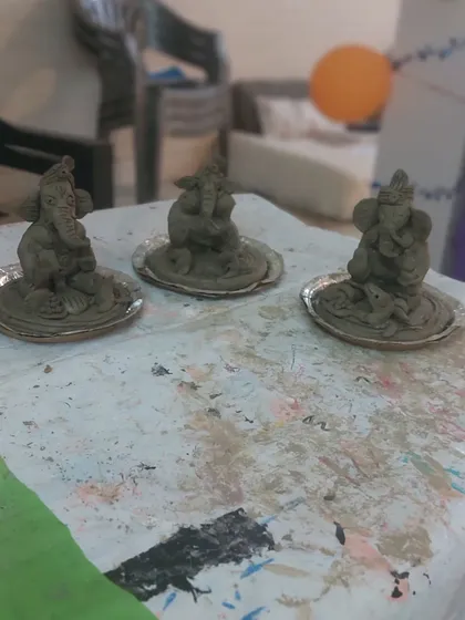 A lineup of eco-friendly Ganesha idols, each uniquely sculpted by a participant. Our workshops focus on using sustainable materials, teaching children to celebrate festivals responsibly.