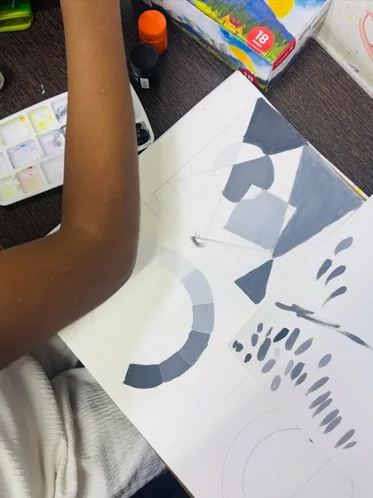 A close up of a student's sketchbook showing exercises in tonal studies. Mastering the transition from black to white through shades of grey is a foundational skill we emphasize.