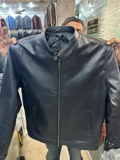 A classic men's leather jacket in black with a central zip and stand up collar. This is a timeless piece, sourced from a trusted leather goods shop in Karachi.