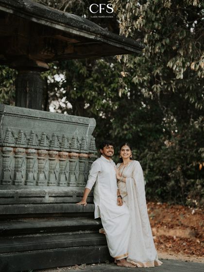 A relaxed and happy portrait of the couple at a heritage site, their comfortable pose showing their easy chemistry.