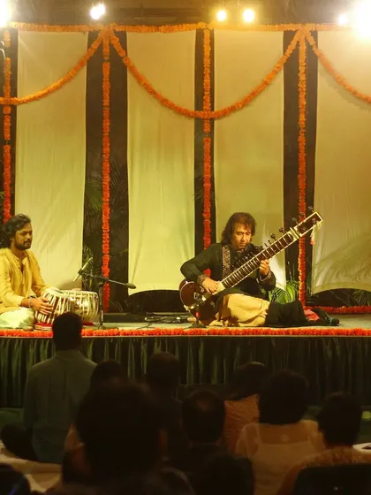 On stage with Ustad Rafique Khan saheb during a sitar recital at the Courtyard Baithak series. My focus is always on the main artist, listening closely to respond to their musical ideas.