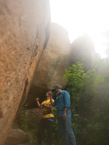 Two climbers discussing beta before a climb. Sharing knowledge and encouraging each other is a core part of our community's spirit.