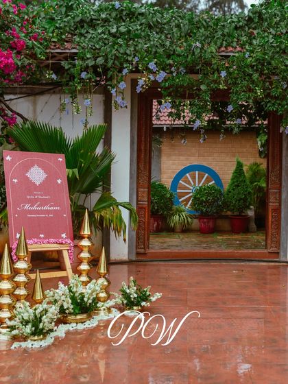 Another shot of the Muhurtham welcome sign, showing its placement within the venue's beautiful, traditional architecture.