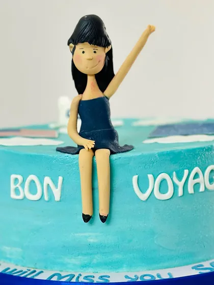 A close-up of the handmade fondant topper for a farewell cake. This figure was customized to look like the girl who was heading off to university.