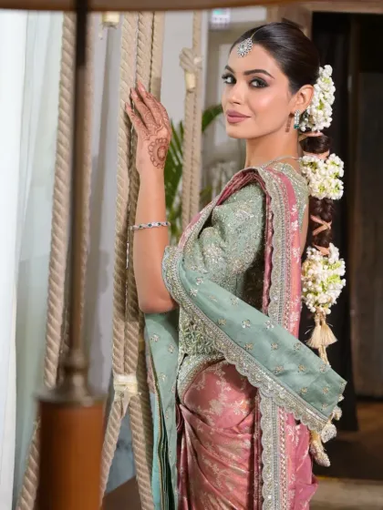 This shot highlights how the floral braid complements the overall bridal ensemble. The sleek front and elaborate back create a balanced look perfect for traditional photoshoots.