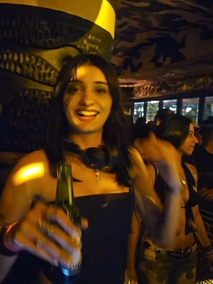 A candid moment enjoying a drink after a set. Even my casual outfits are a reflection of my style, mixing comfort with a bit of edge.