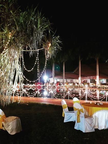 A closer view of the tree and seating area decorated with fairy lights. The warm lighting creates a cozy and inviting spot for guests to relax.