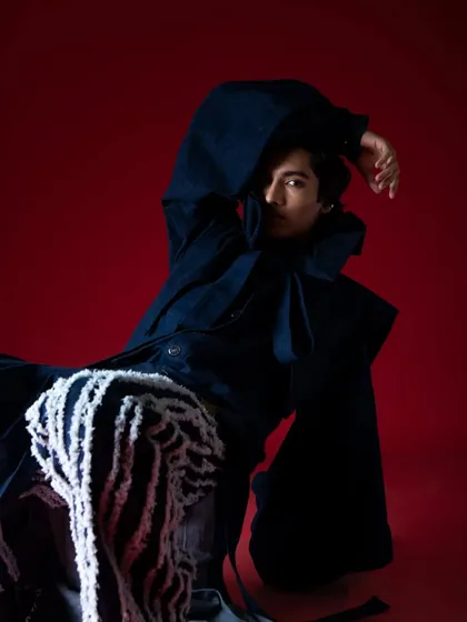 Creating movement and drama within a studio space. This pose highlights the volume of the sleeves and the texture of the pants.
