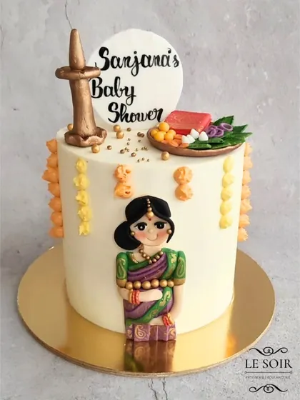 It was an honor to create this special Seemantham (baby shower) cake. This 2kg Vanilla Caramel cake features a hand-crafted figurine of the mom-to-be, a traditional lamp, and a platter with tiny, intricate fondant offerings for the ceremony.