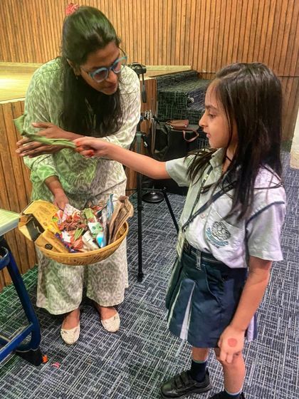 A student at St. Xavier's participates in our waste segregation game. By sorting through a basket of mixed waste, children learn to identify what is recyclable, what is compostable, and what needs to be disposed of responsibly.