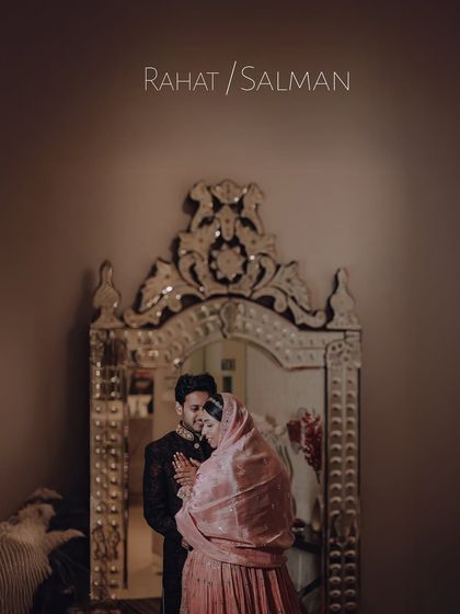 An artistic and moody engagement portrait, with the couple reflected in an ornate mirror, creating a timeless and royal feel.