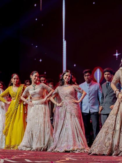 A fun moment where the bride and groom are playfully quizzed by the bridesmaids during a performance. Interactive elements like this make the sangeet more engaging.