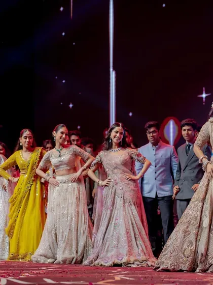 A fun moment where the bride and groom are playfully quizzed by the bridesmaids during a performance. Interactive elements like this make the sangeet more engaging.