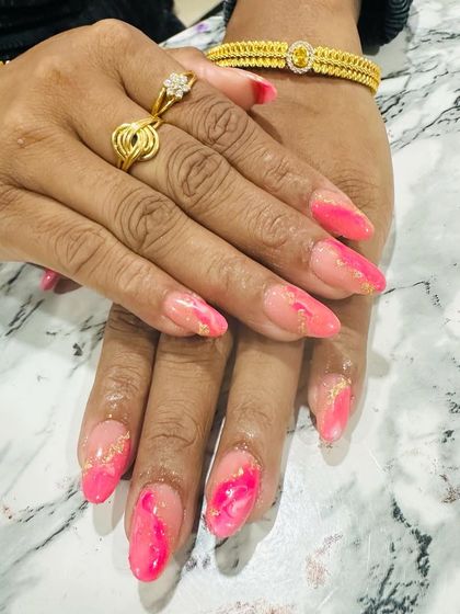 A beautiful pink marble or watercolor effect, with delicate gold foil flakes embedded in the design.