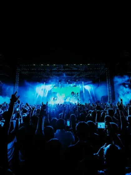 The iconic 'horns up' from a packed crowd at the Dream Theater concert. We don't just sell tickets; we build an atmosphere of pure energy and dedication for true music fans.