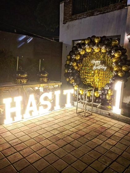 The outdoor setup at night, with the marquee letters and neon sign brightly lit.