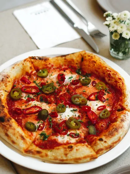 For those who like it spicy, our Piccante pizza is the perfect choice. It's topped with our classic tomato sauce, fresh mozzarella, jalapeños, and red chillies.