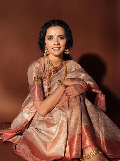 A wider shot from the same traditional series, showcasing the full effect of the makeup with the beautiful Kanchipuram silk saree and gold jewelry.