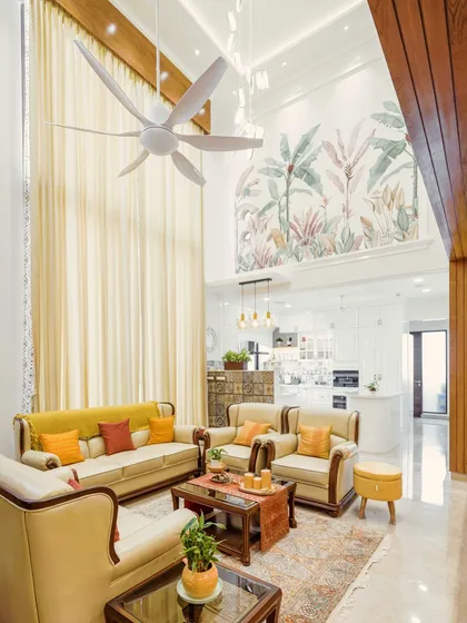This is where my design philosophy comes to life. I transformed this penthouse living area with a double-height ceiling into a warm, inviting space that balances grandeur with comfort. The hand-painted mural, custom lighting, and open-plan layout leading to the kitchen show how I handle large-scale projects, ensuring every element works in harmony to create a home with soul.