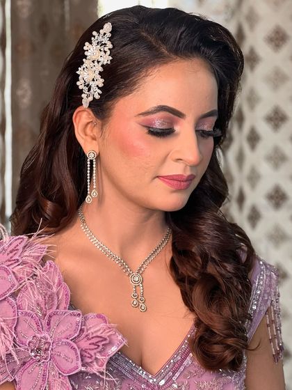 A side profile showcasing the beautiful hairstyle with a crystal hairpiece and the soft, blended eye makeup.