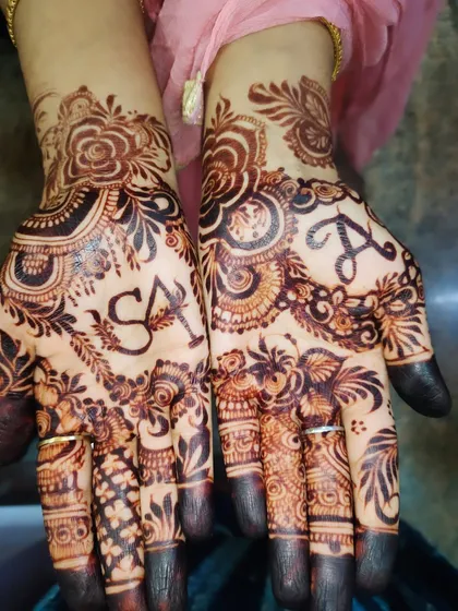 Adding a personal touch with custom initials. I can seamlessly weave your and your partner's initials into the traditional mehndi design, as seen here with 'S' and 'A' on the palms.