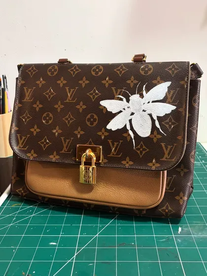 The bee sketch on the LV bag, now filled in with a solid white base coat, getting it ready for all the color and detail.
