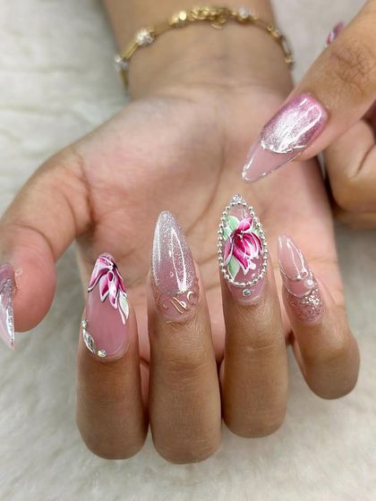 Luxe bridal nails featuring hand-painted lotus flowers framed with delicate crystals. This design combines traditional motifs with modern techniques for a truly unique look.