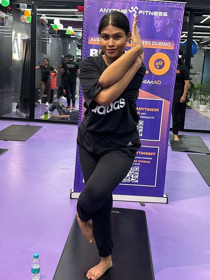 This member shows great form and concentration in the Eagle Pose. Regular practice in our classes helps improve such balancing postures.