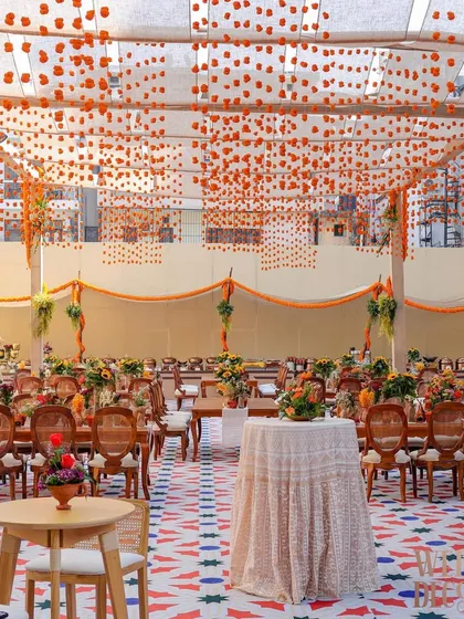 We brought the vibrant soul of Old Delhi to a sun-drenched brunch. This wide view captures the full experience, from the custom-printed flooring and tented ceiling with hanging marigolds to the comfortable seating areas, creating a perfect setting for a festive chaat party.
