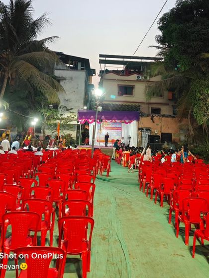 Rows of red plastic chairs set up for an outdoor live singing event. I can provide and arrange seating for any number of guests.