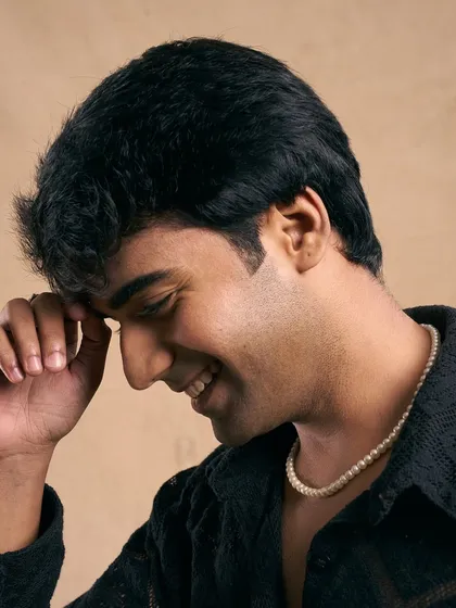 A candid, laughing shot. The grooming is polished but not overdone, creating a look that is both charming and timeless.