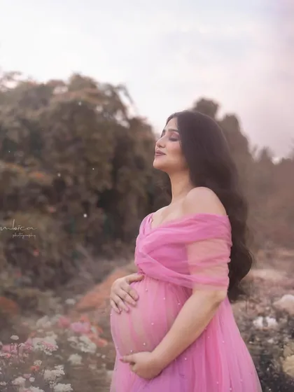 The color version of the same blissful moment. The soft pink of the gown and the muted colors of the field create a warm, gentle, and romantic image.