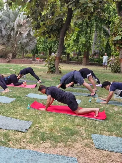 A group of yogis flowing through a sequence in the park. The uneven ground adds an extra challenge to our balance and focus.