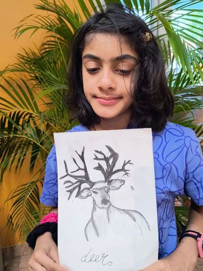 A duplicate image of a student with her graceful deer sketch, showing her developing skills in realistic drawing and shading.